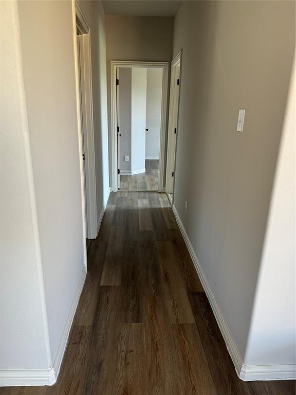 236 Archer Way Forney, TX 75126 - Photo 16 of 35 a view of a hallway with wooden floor and a bathroom