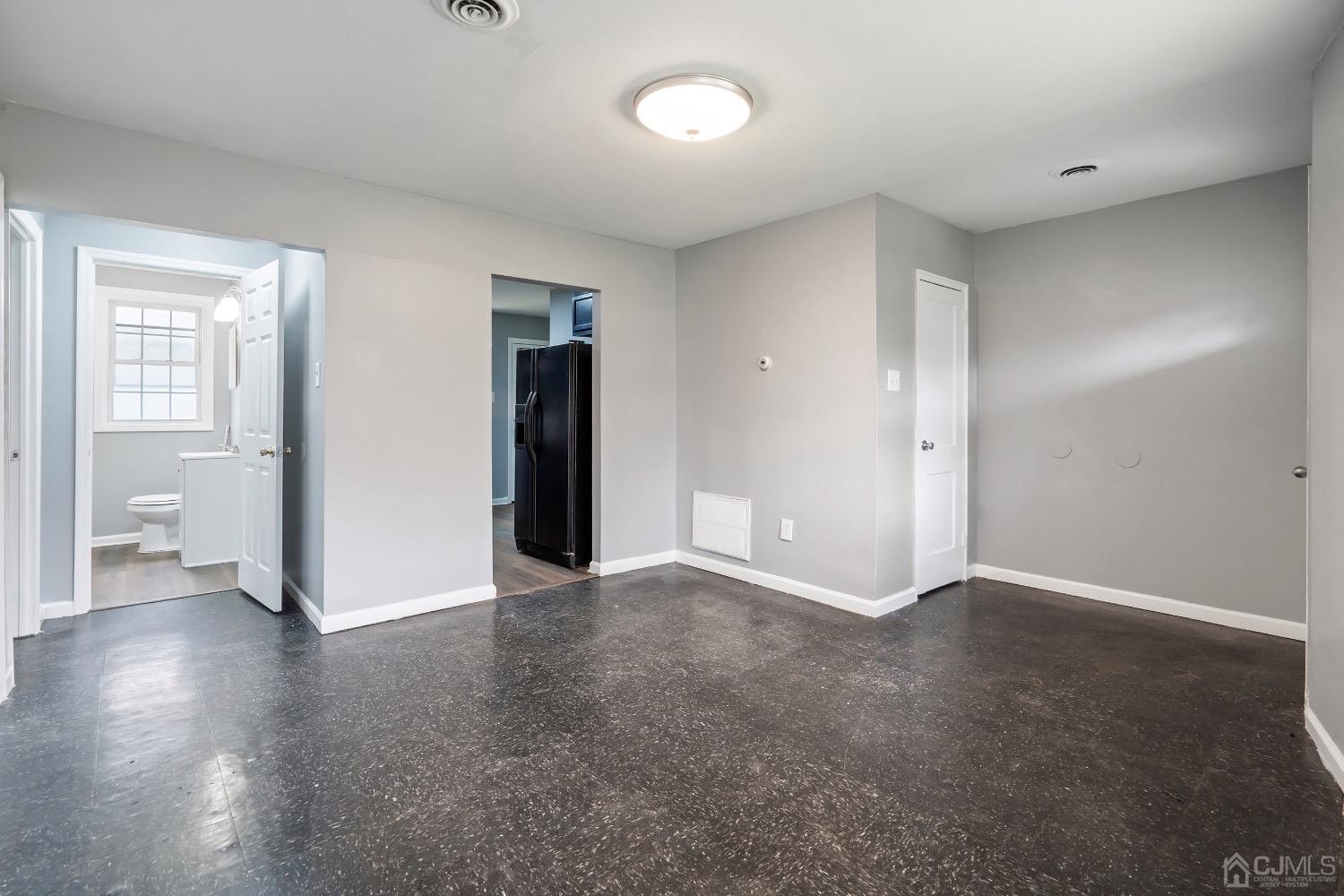 211 Kinsley Road Pemberton, NJ 08068 - Photo 4 of 15 an empty room with wooden floor and a window