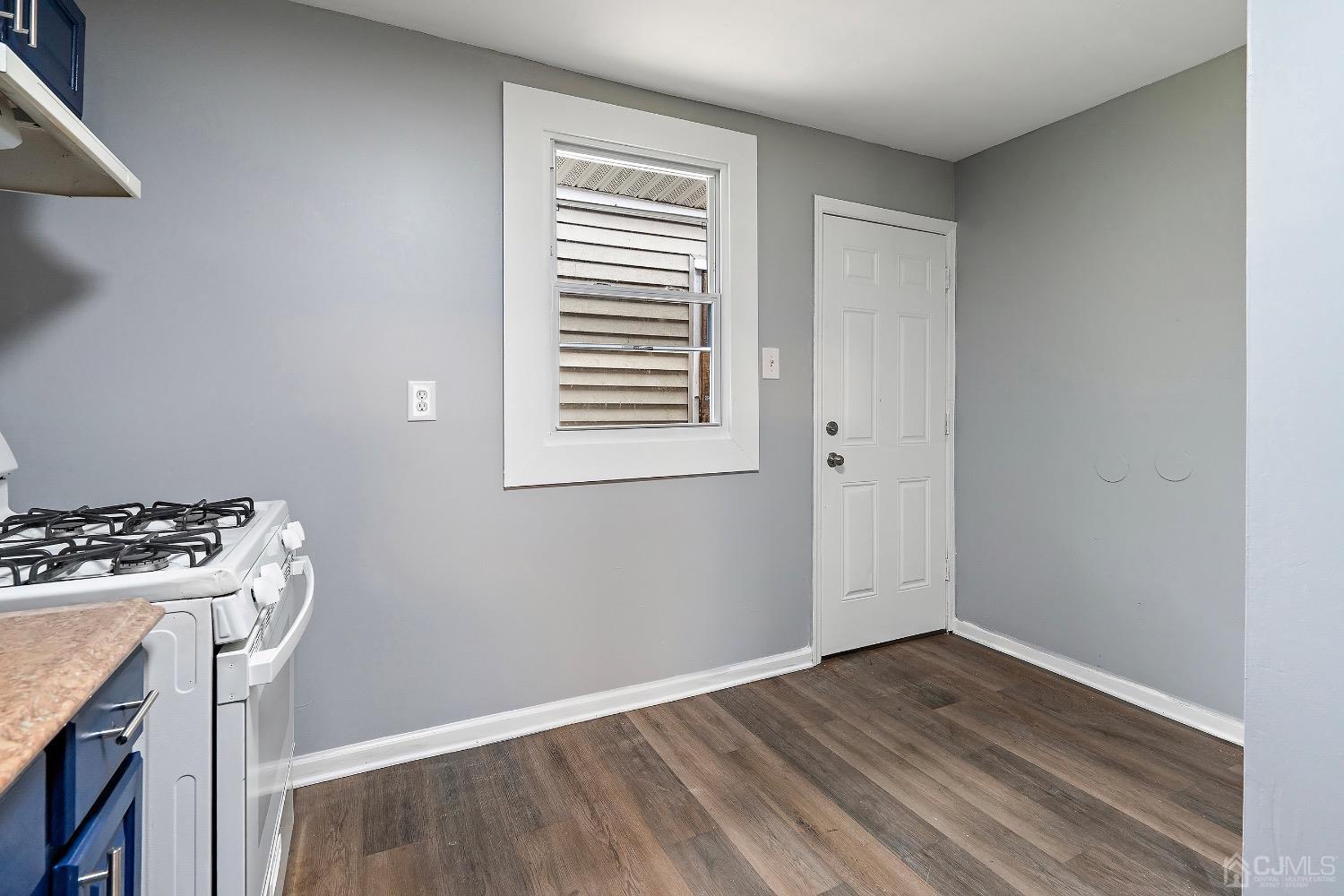 211 Kinsley Road Pemberton, NJ 08068 - Photo 10 of 15 a view of a room that has a stove and a wooden floor