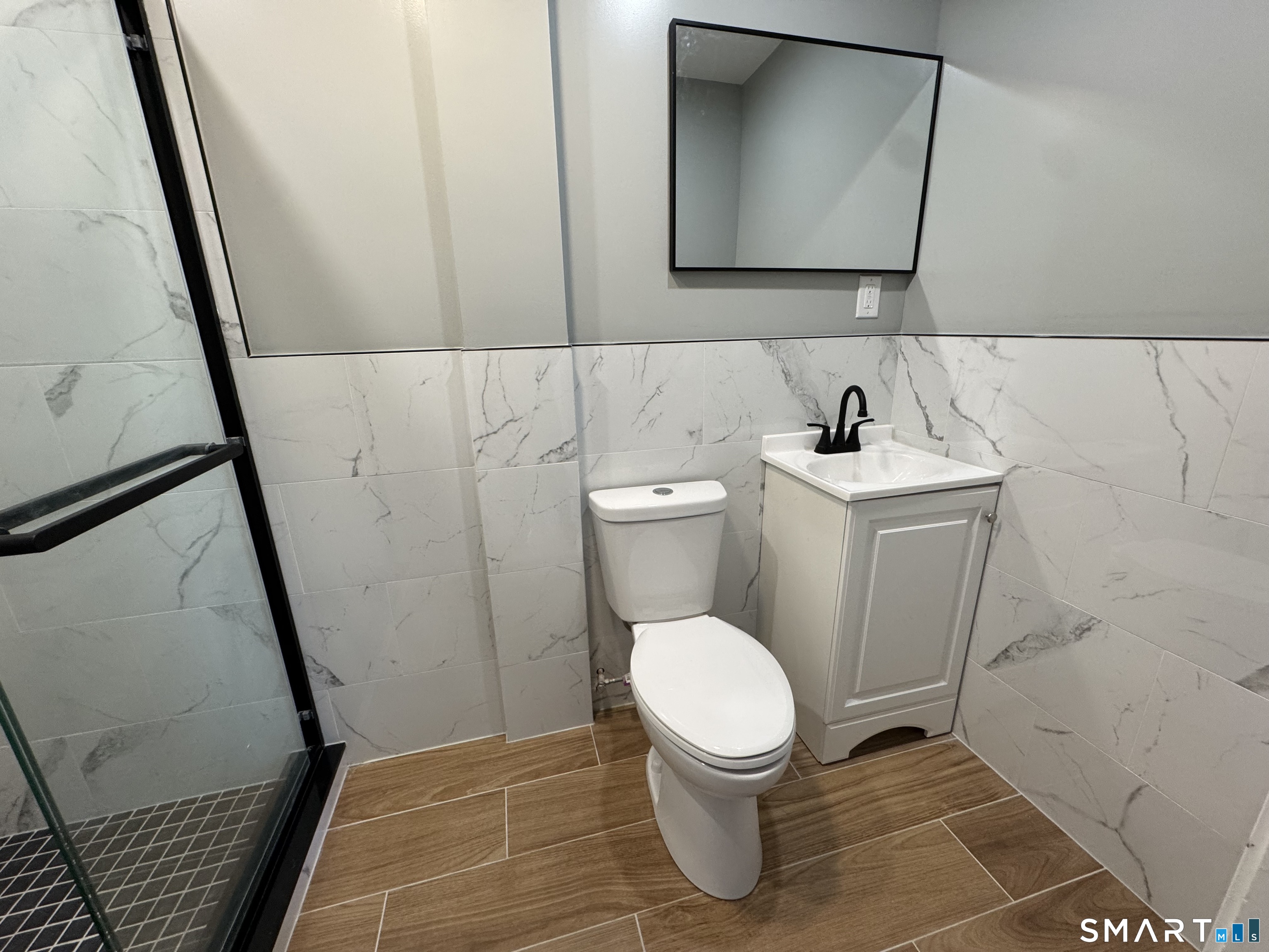 299 Linnmoore Street Hartford, CT 06106 - Photo 14 of 23 a bathroom with a toilet and a sink