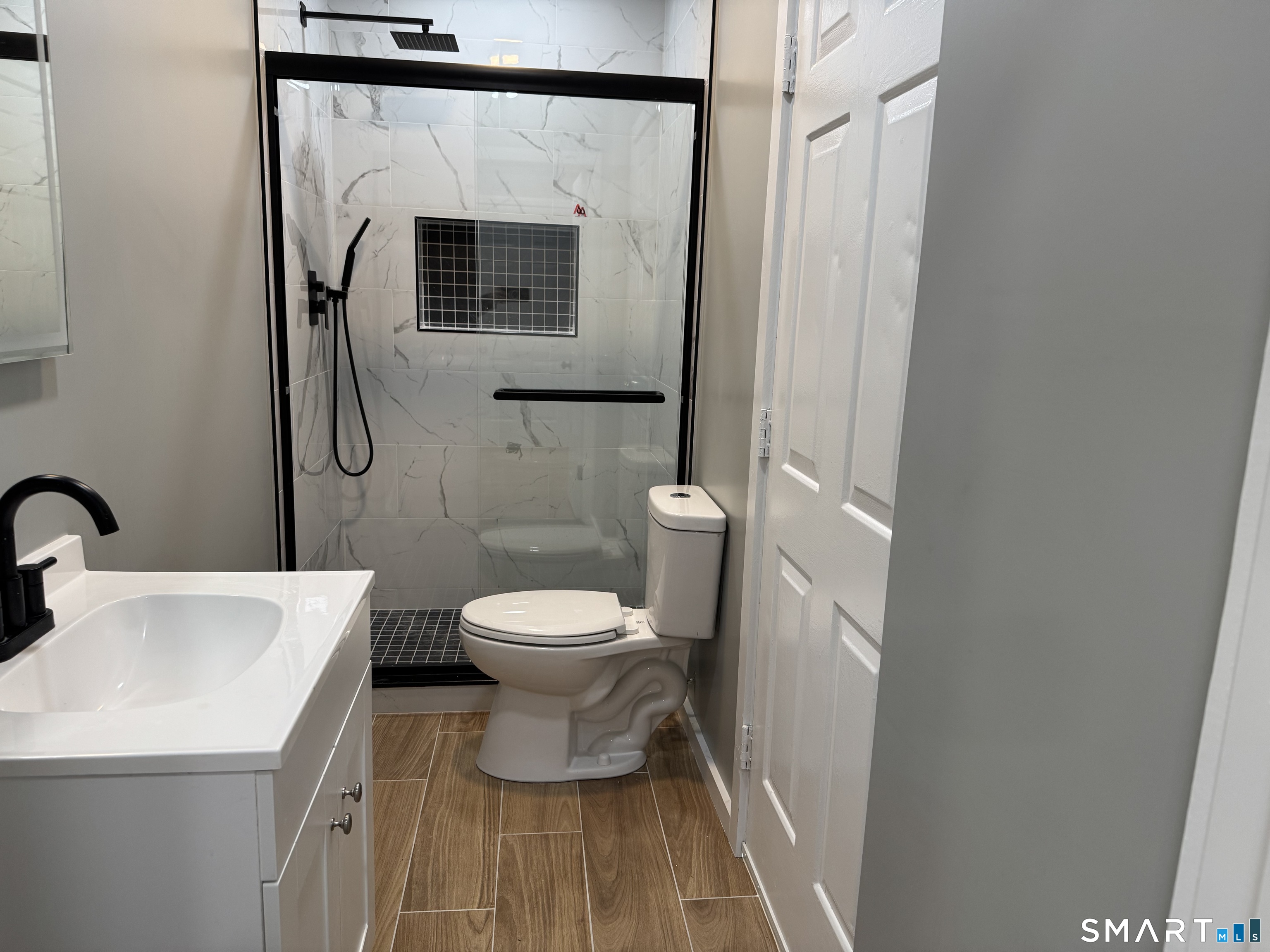 299 Linnmoore Street Hartford, CT 06106 - Photo 4 of 23 a bathroom with a toilet and a sink