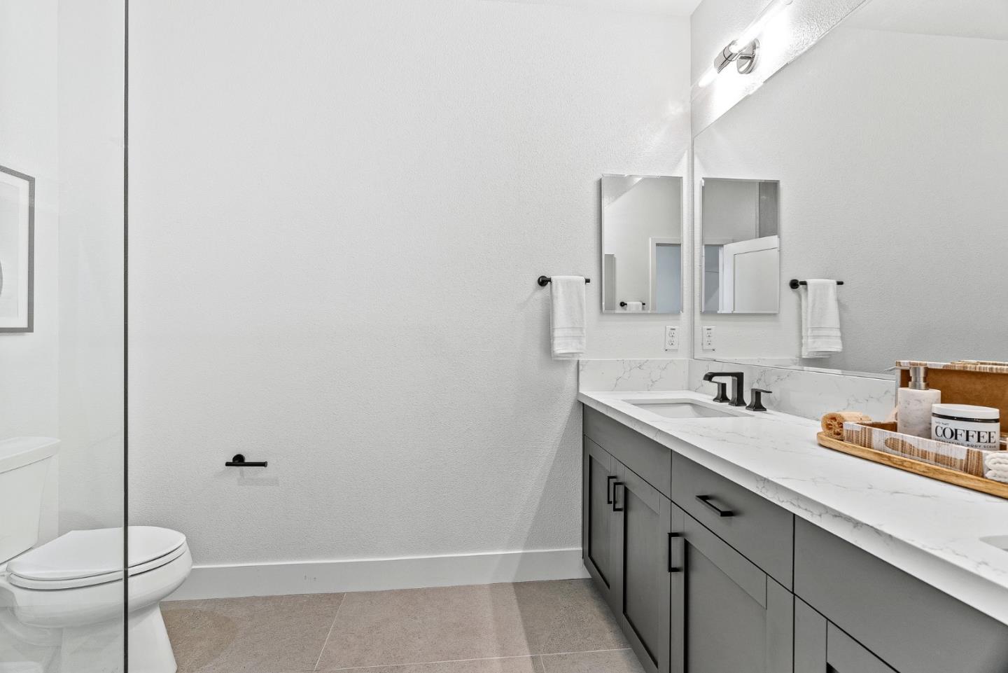 943 Woodside Road Redwood City, CA 94061 - Photo 27 of 30 a bathroom with a sink a toilet and shower