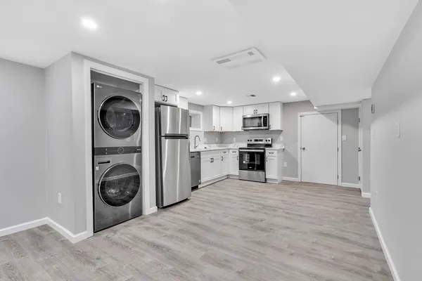 a view of a kitchen with a washer and dryer