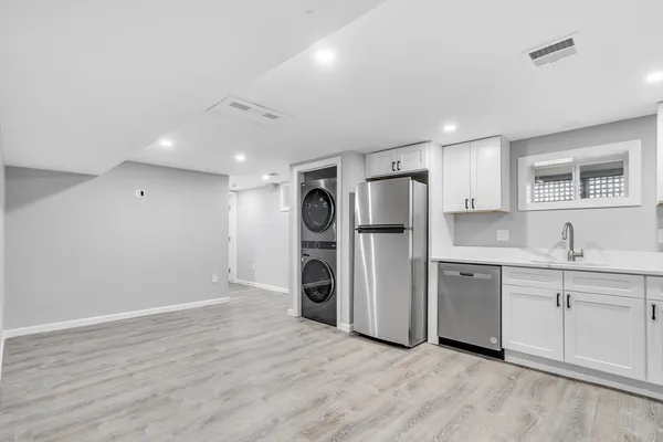 a large kitchen with a refrigerator a sink and dishwasher