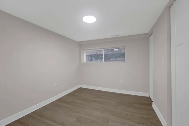 a view of a room with wooden floor and window