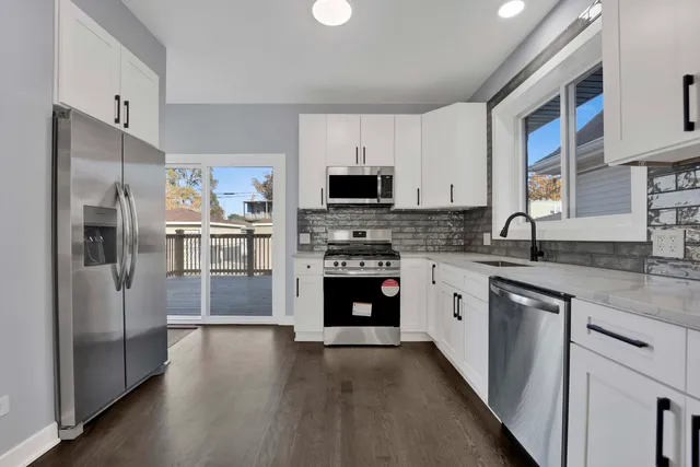 a kitchen with a refrigerator stove and sink