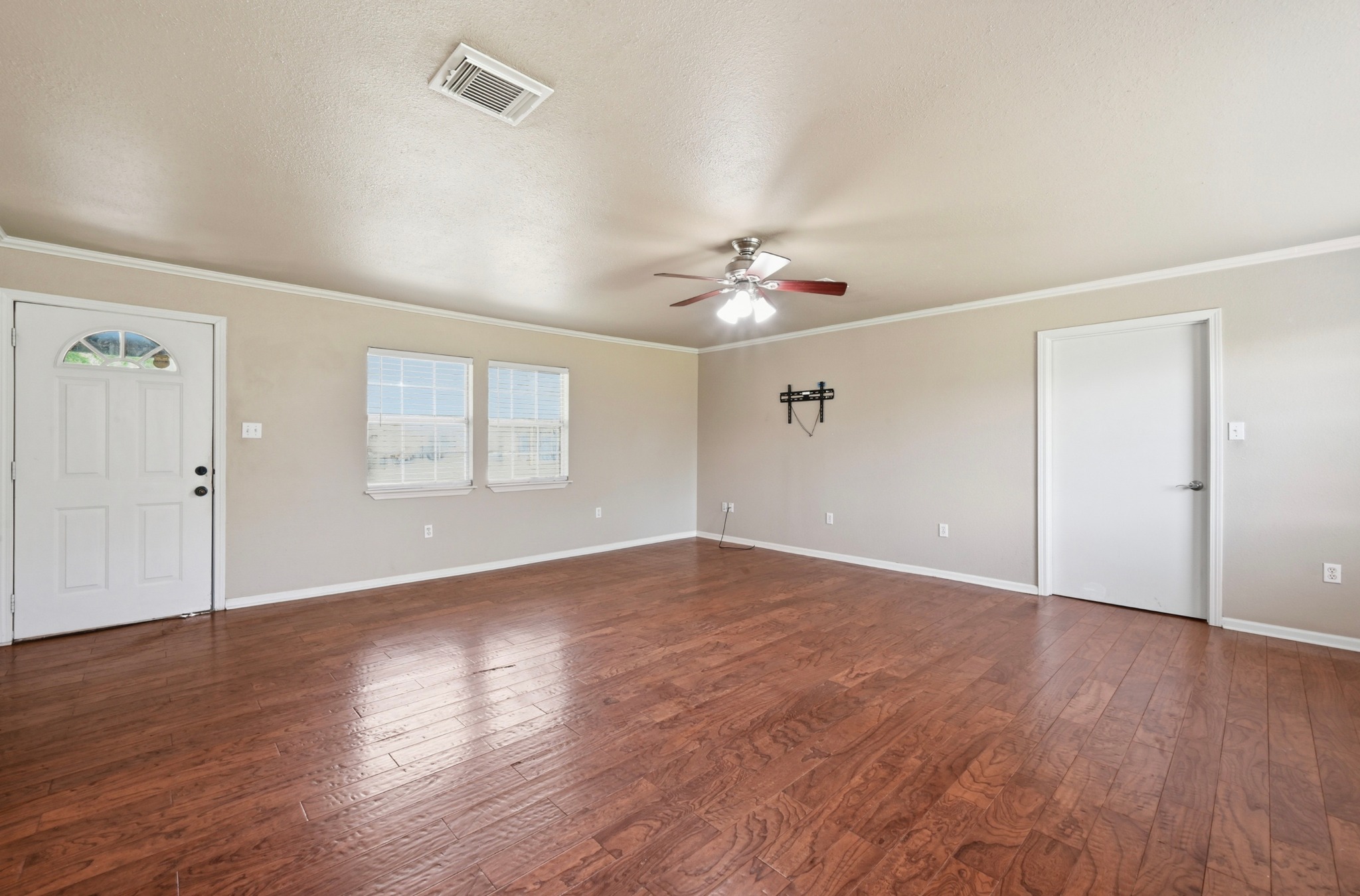 1127 Parr Street Luling, TX 78648 - Photo 8 of 20 Hardwood floors and ample natural light define this welcoming living space.