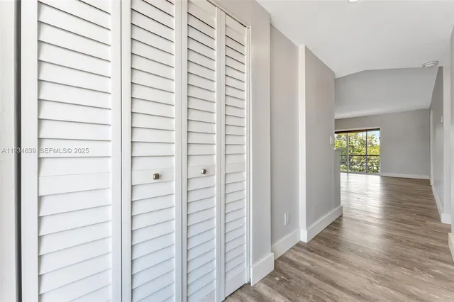 a view of hallway with wooden floor