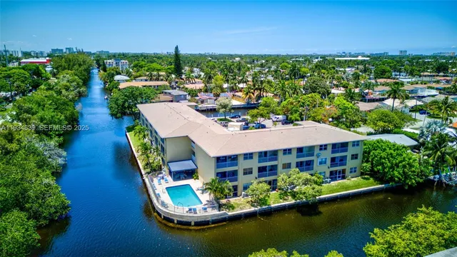 an aerial view of a house with swimming pool outdoor seating and yard