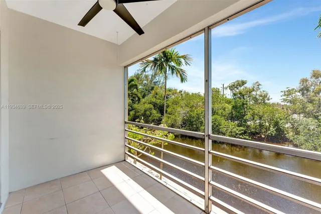 a view of outdoor space with wooden floor and windows