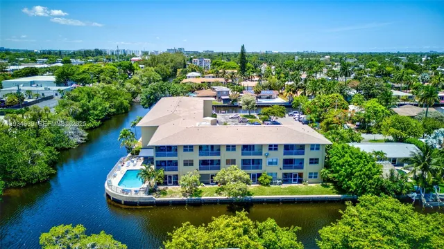a view of a lake with a house swimming pool and outdoor space