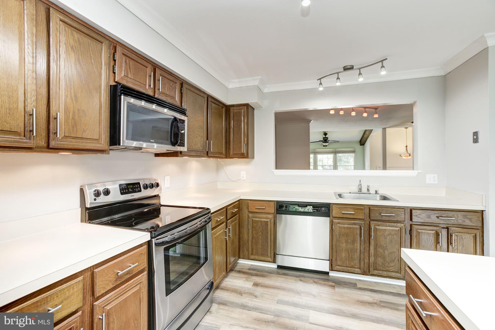 7531 Swan Point Way, Unit 192 Columbia, MD 21045 - Photo 12 of 35 Under cabinet lighting; kitchen looks into dining