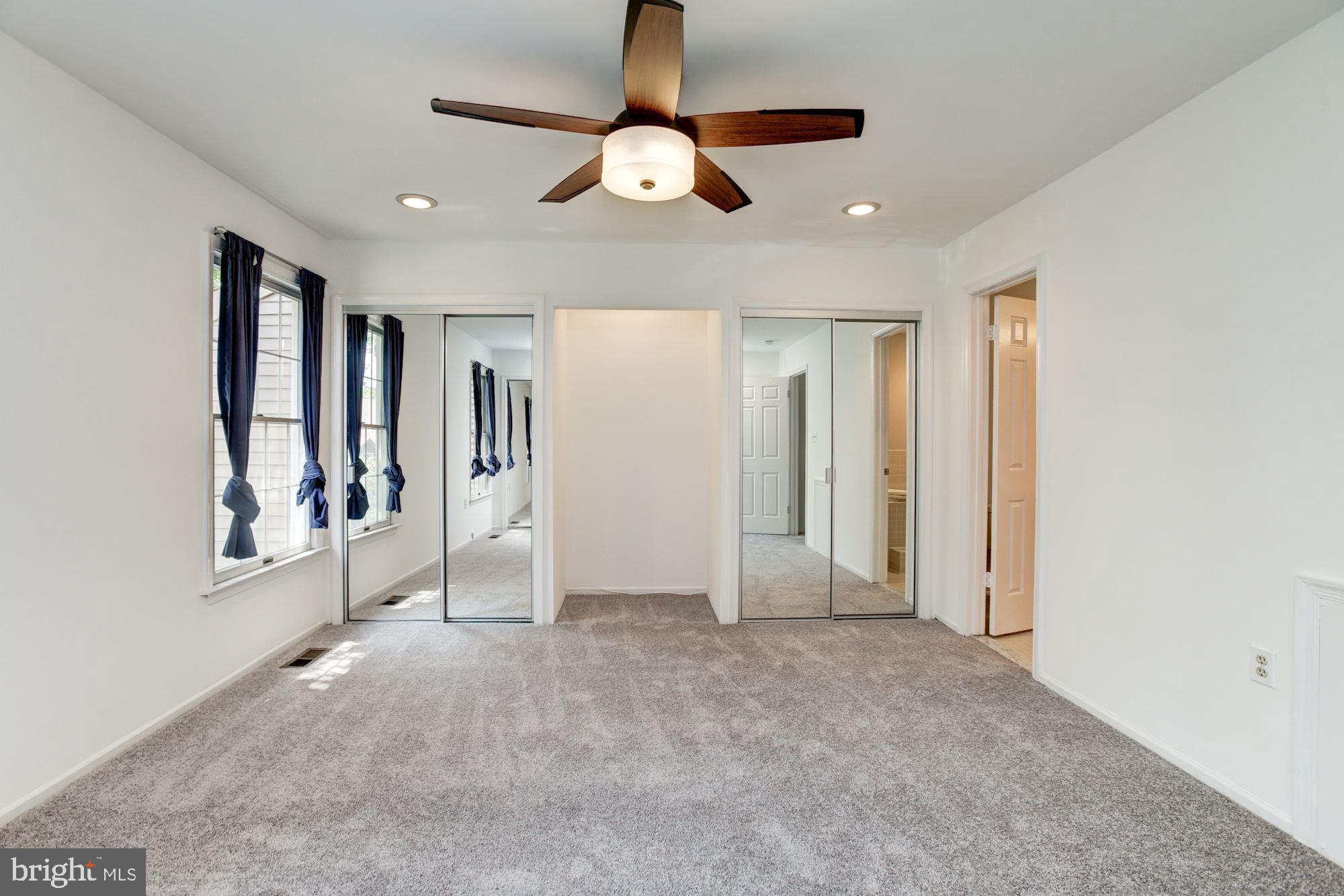 7531 Swan Point Way, Unit 192 Columbia, MD 21045 - Photo 16 of 35 Master bedroom w/ ceiling fan and bathroom