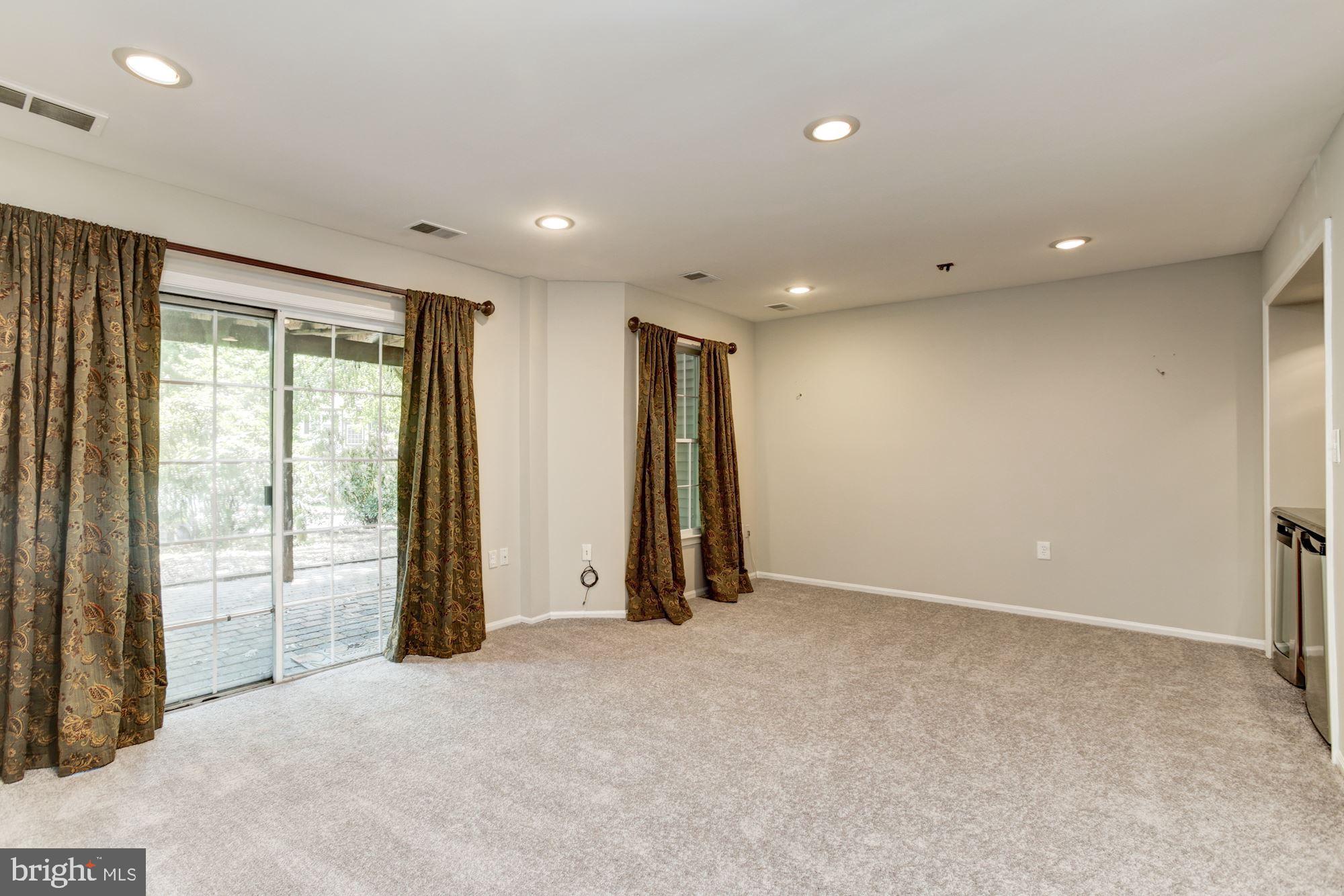 7531 Swan Point Way, Unit 192 Columbia, MD 21045 - Photo 26 of 35 Lower level rec room slider leads to paver patio