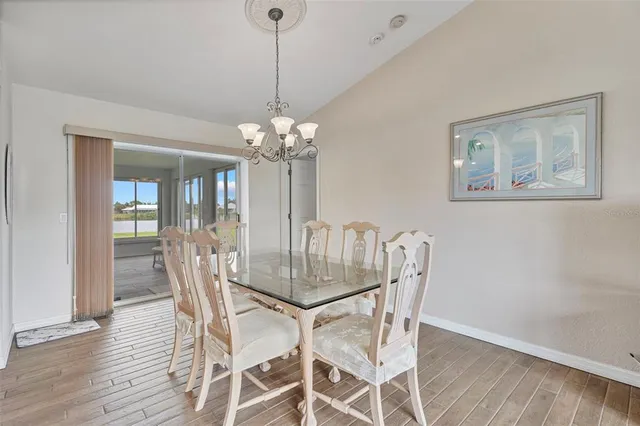 a view of a dining room with furniture wooden floor and chandelier