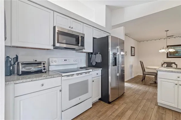 a kitchen with stainless steel appliances a stove microwave and refrigerator