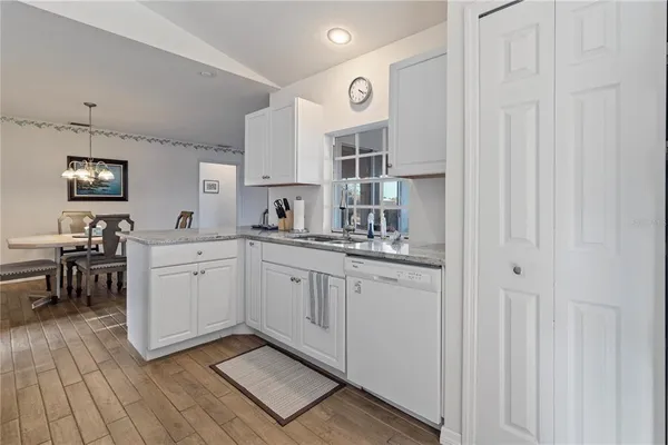 a kitchen with cabinets oven and a sink