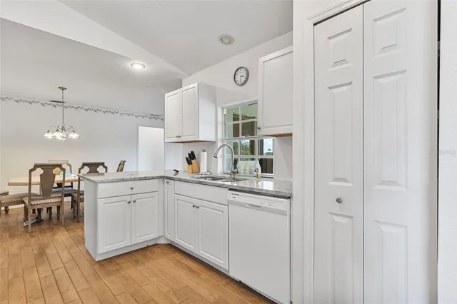 a kitchen with cabinets and chairs