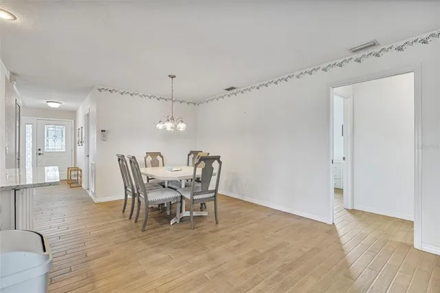 a dining room with furniture and wooden floor
