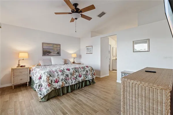 a bedroom with a bed and wooden floor