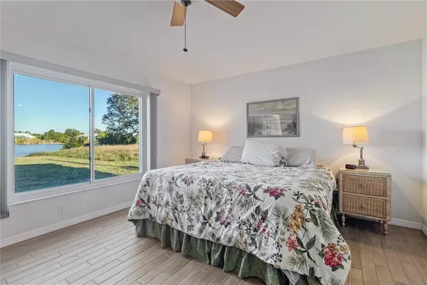 a bedroom with a bed and large window