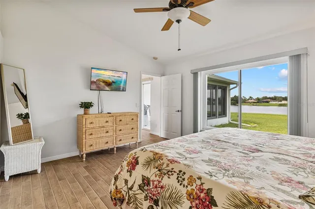 a bedroom with a bed and a view of living room