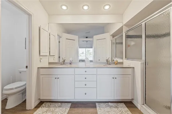 a spacious bathroom with a granite countertop sink mirror and toilet