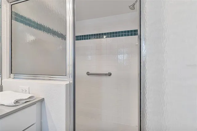a bathroom with a shower and a sink