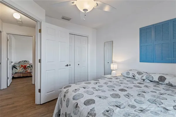 a bedroom with a bed and a lamp