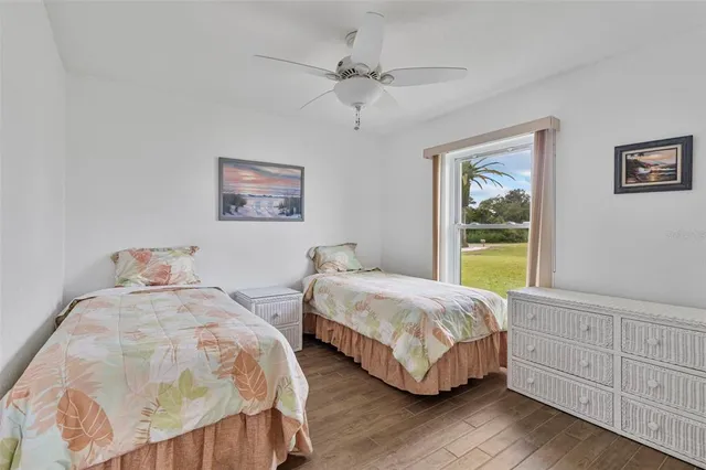 a bedroom with two beds and painting on the wall