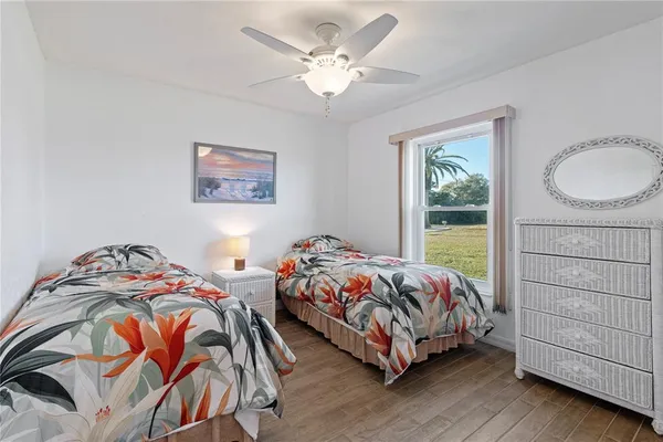 a bedroom with two beds and a window