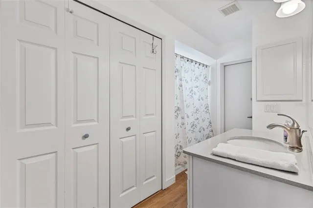 a bathroom with a granite countertop sink a toilet and a mirror