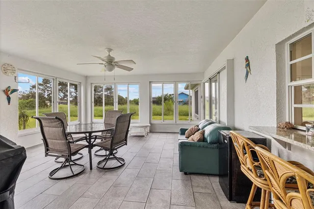 a living room with furniture and a floor to ceiling window