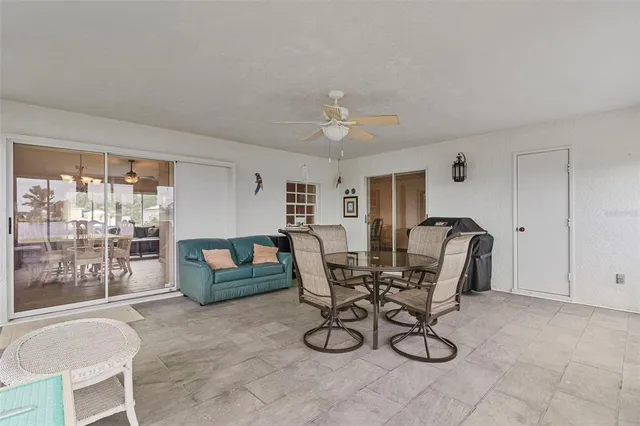 a view of a house with backyard sitting area and garden