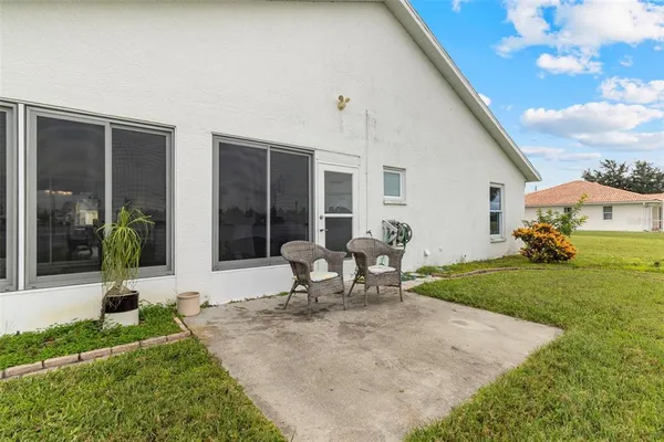 a view of a house with backyard sitting area and garden