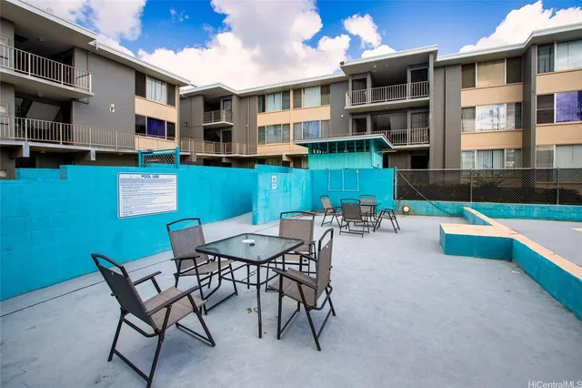 a view of a chairs and table in the patio