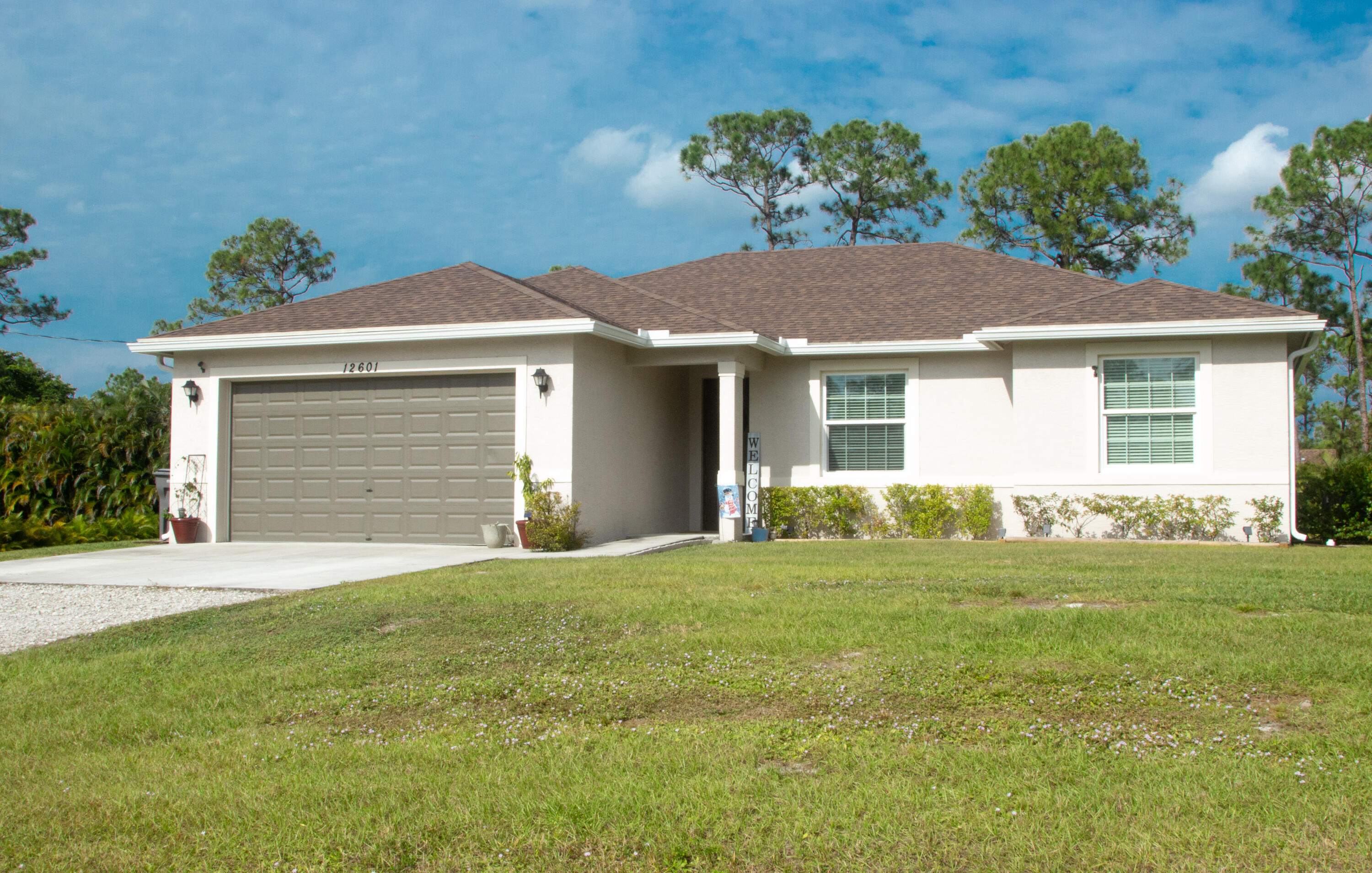 a front view of a house with a garden