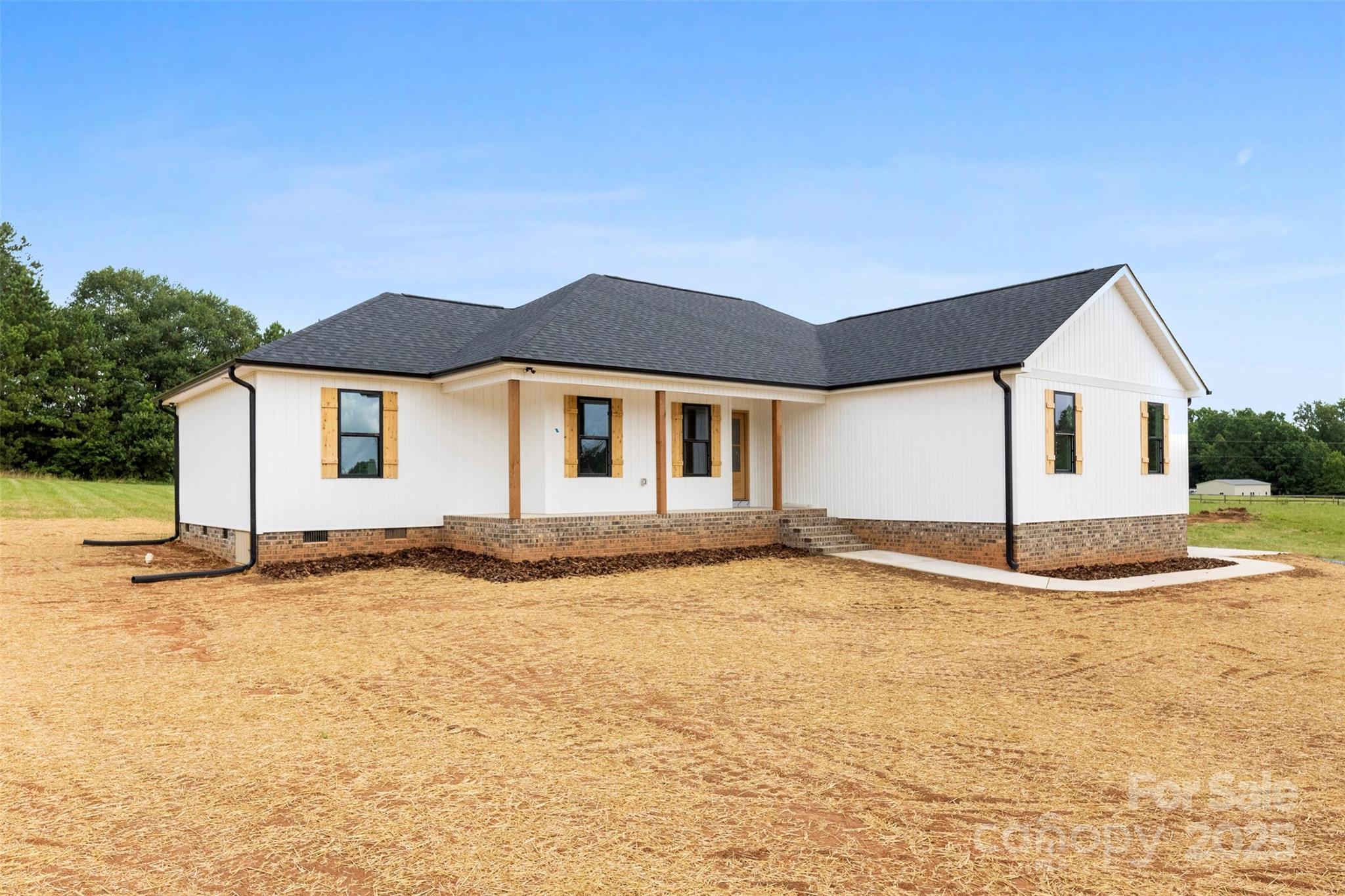 a view of a house with a yard and sitting area