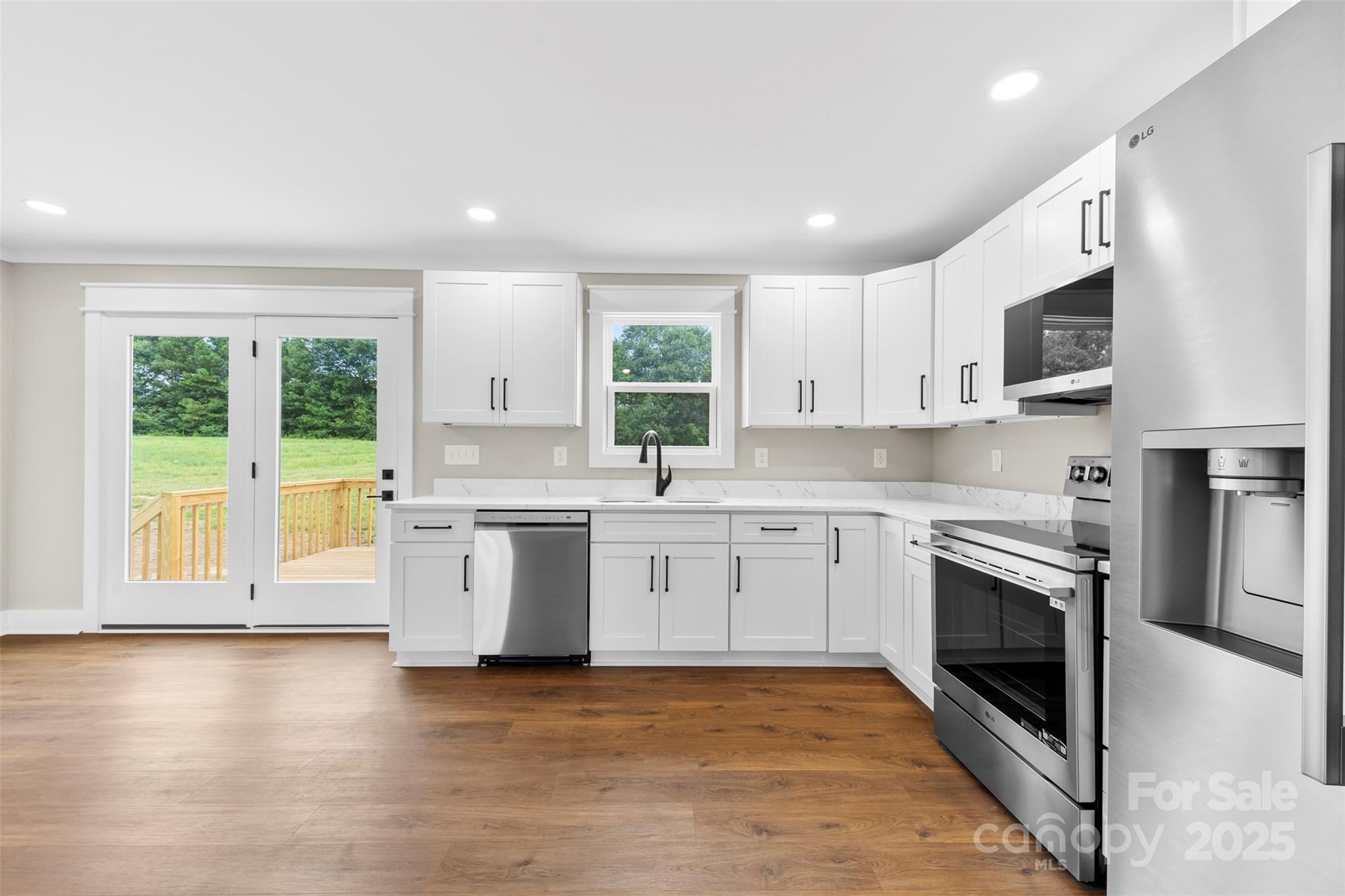 6788 Clyde Wehunt Road Cherryville, NC 28021 - Photo 4 of 25 a kitchen with stainless steel appliances granite countertop a stove a sink and a microwave