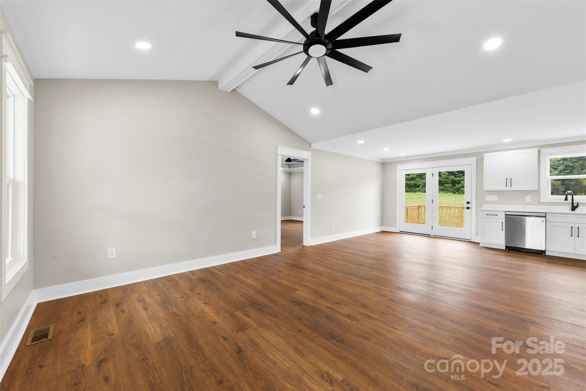 6788 Clyde Wehunt Road Cherryville, NC 28021 - Photo 6 of 25 an empty room with wooden floor fan and windows