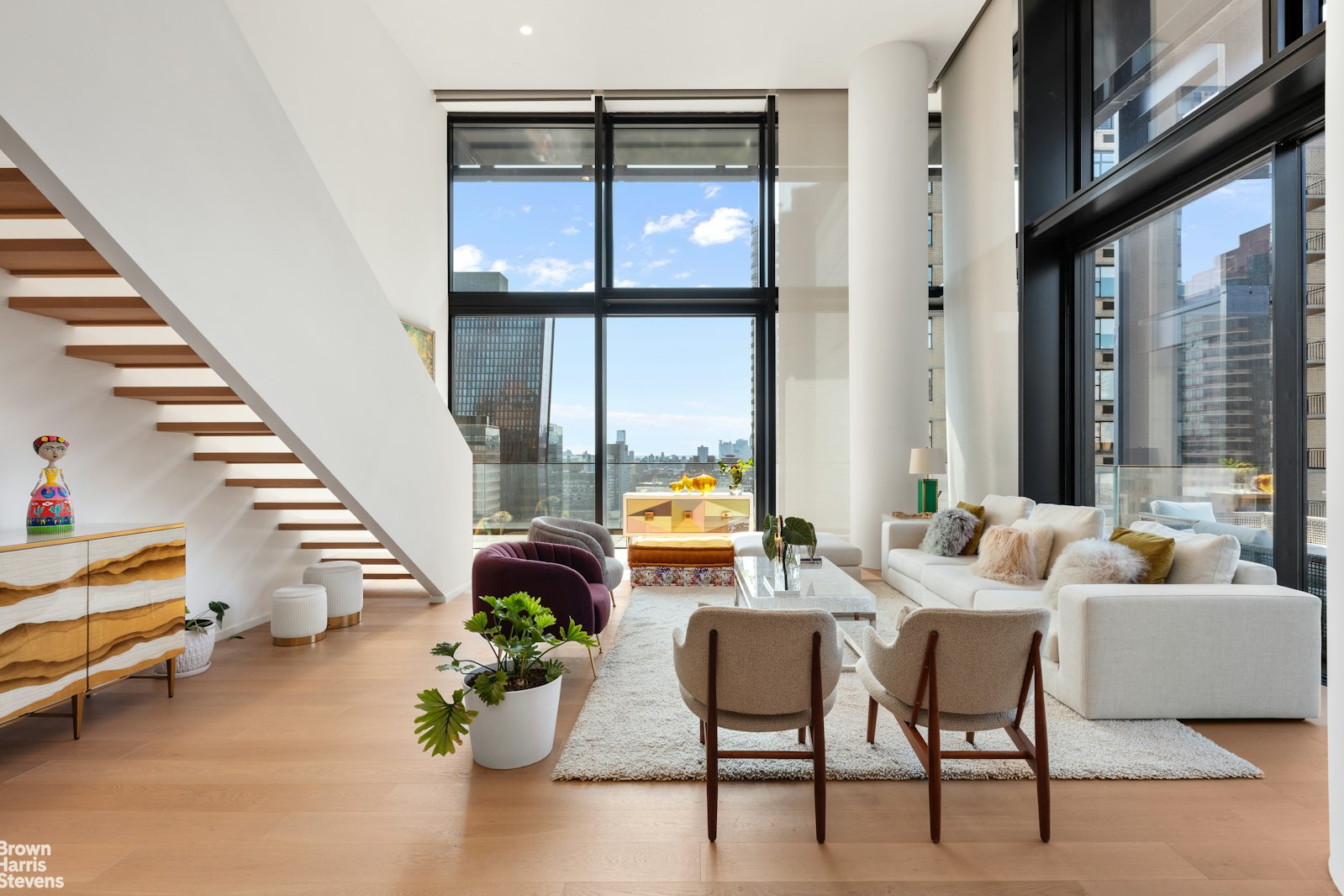 695 1st Avenue, Unit 28E Manhattan, NY 10016 - Photo 4 of 15 a living room with furniture and floor to ceiling windows