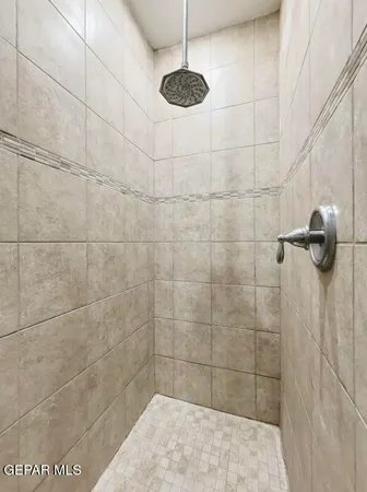 a bathroom with a granite countertop sink a mirror and bathtub