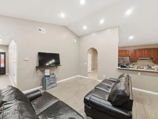 a living room with furniture and a flat screen tv