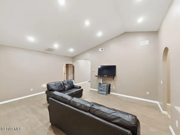a living room with furniture and a flat screen tv