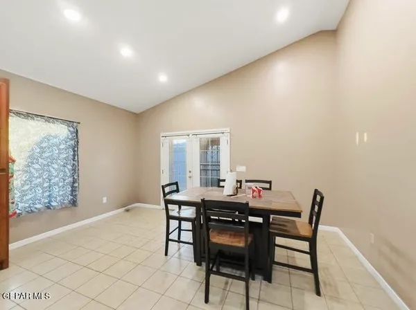a dining room with furniture and wooden floor