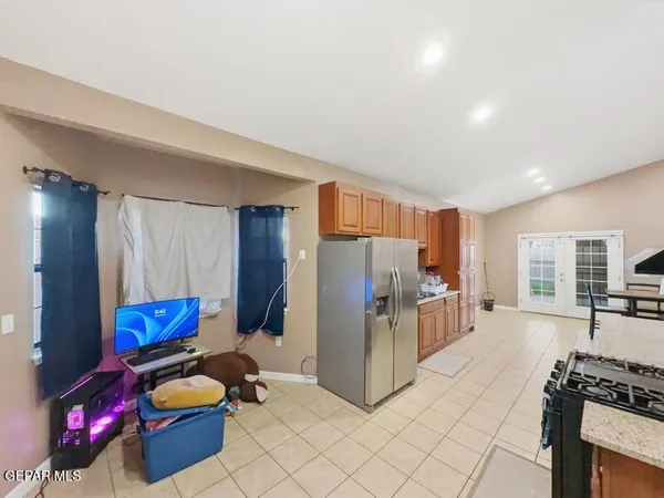 a kitchen with stainless steel appliances granite countertop a refrigerator and a stove top oven