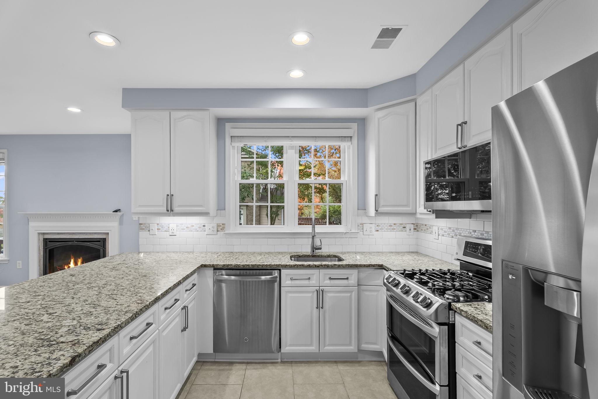 6267 Taliaferro Way Alexandria, VA 22315 - Photo 15 of 49 a kitchen with stainless steel appliances granite countertop a stove a sink dishwasher a refrigerator and a microwave