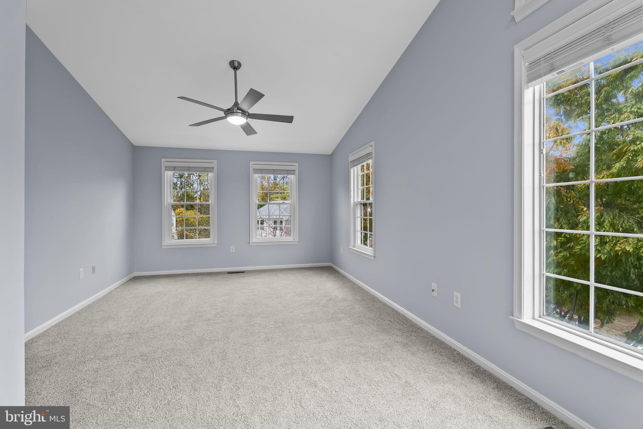 6267 Taliaferro Way Alexandria, VA 22315 - Photo 23 of 49 an empty room with windows and ceiling fan