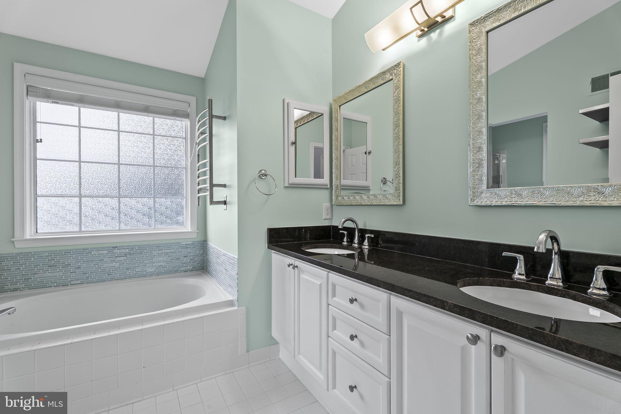 6267 Taliaferro Way Alexandria, VA 22315 - Photo 24 of 49 a bathroom with a granite countertop sink mirror bathtub and shower