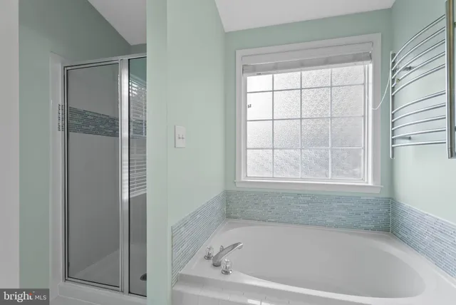 a white bath tub sitting next to a window